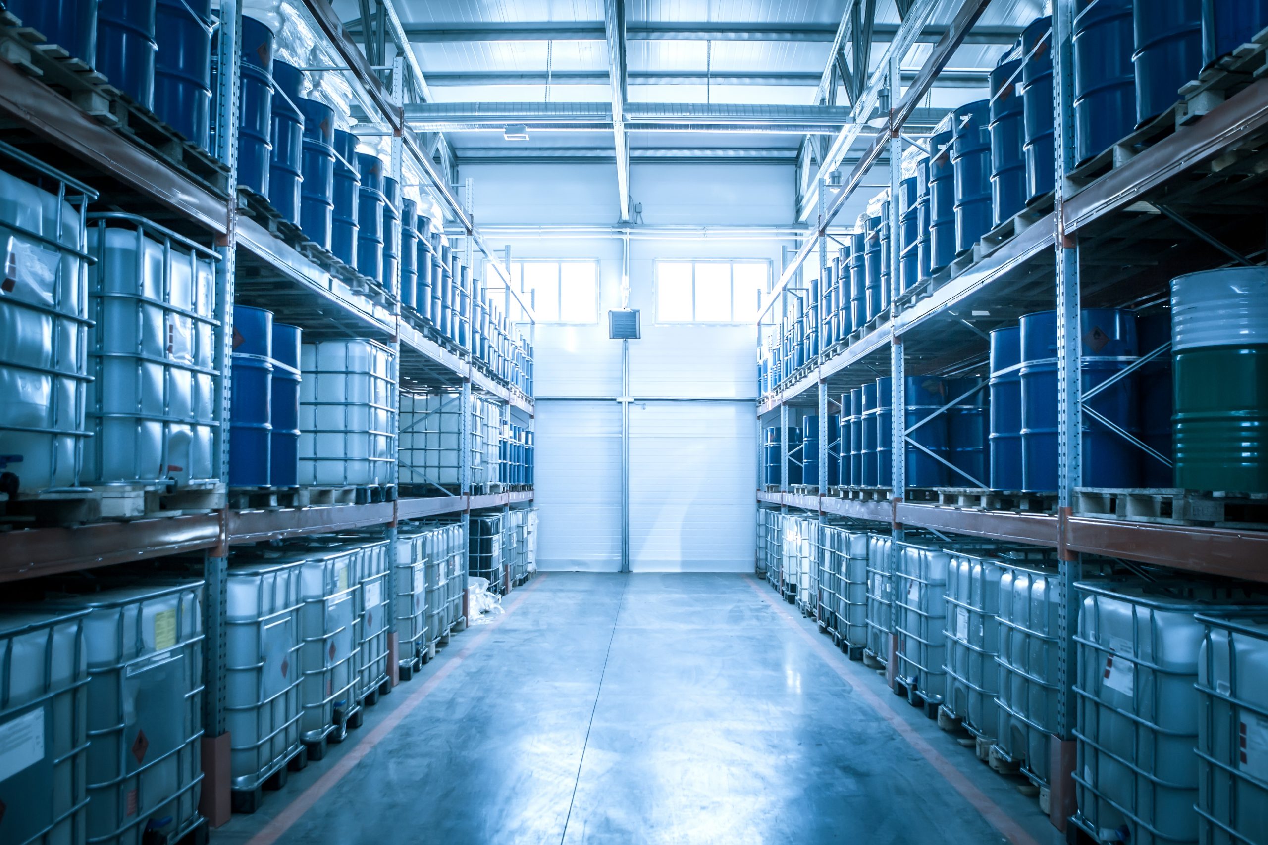 Chemical warehouse. Barrels with chemical products. Shelvings with barrels. Warehouse shelving.