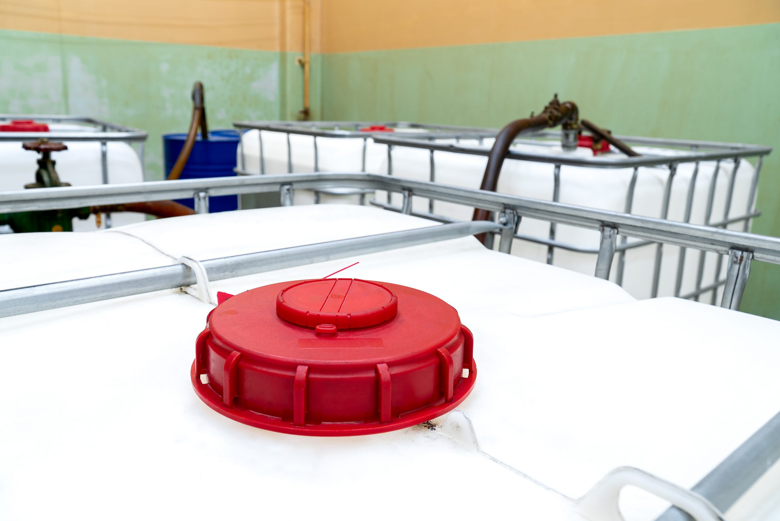 Overhead view inside of the factory. The large white tanks red l